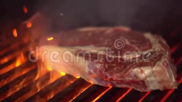 厨师用肉钳在烤架上转动一块肉一块美味的肉和烤架上的烤条视频的预览图