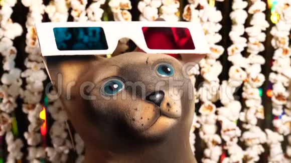 猫雕像在3D眼镜爆米花和金色闪闪发光的金属圈的动态背景离焦视频的预览图