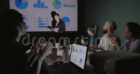 执行人员审查投影仪上的图表并讨论市场上可能的动向视频的预览图