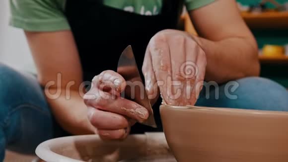 陶工用肩胛骨雕刻出粘土辅助的图形视频的预览图