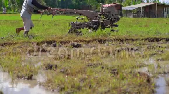 东南亚的农民用手拖拉机犁稻田旅游亚洲概念慢动作视频视频的预览图