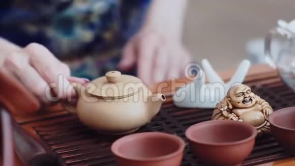 在一张木桌上有一套供中国茶道用的茶具在盖湾倒了香浓的绿茶视频的预览图