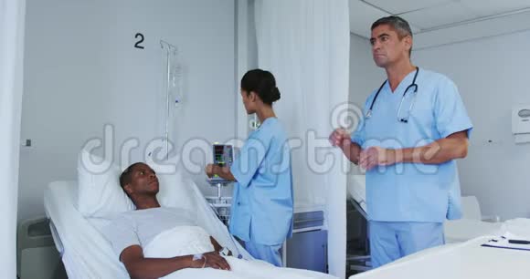 高加索男医生在医院病房使用隐形屏幕的正面视图视频的预览图