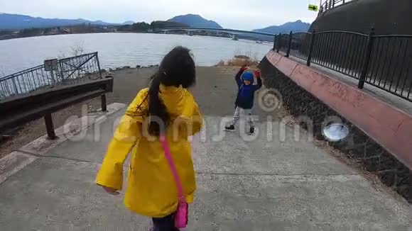 两位兄弟姐妹游客走在川川子湖边背景是富士山景观视频的预览图