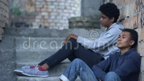 可怜的孤独少年互相看着对方坐在废弃的楼房里困难视频的预览图