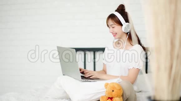 十几岁的年轻人在网上和床上的笔记本电脑聊天视频的预览图