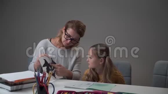 聪明的高加索女人向小女孩解释罗夏的测试卡女性高加索心理学家诊断视频的预览图