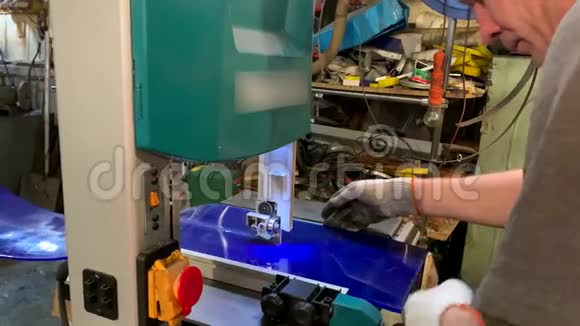 在机器后面的人一个锯子切割了一个聚氨酯板视频的预览图