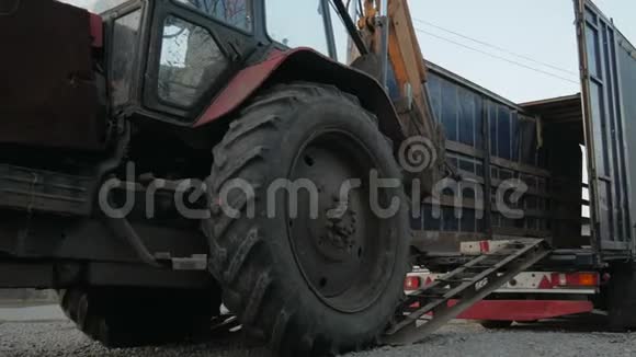 拖拉机挖掘机投入一个长卡车平台视频的预览图