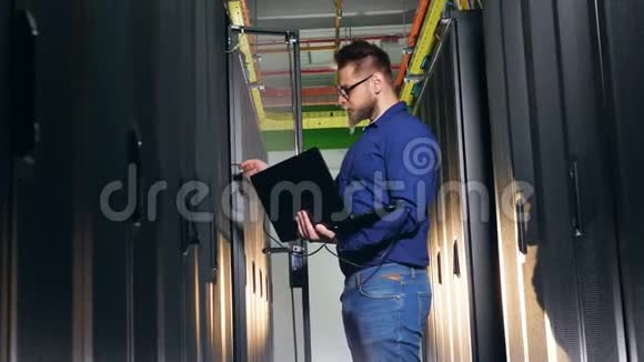 计算机工程师检查服务器机房的计算机使用笔记本电脑视频的预览图