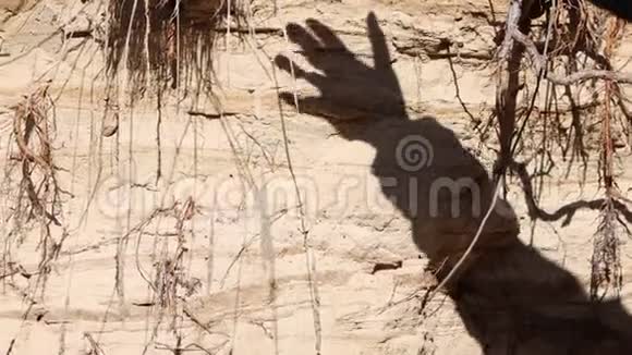 一只雌性手的影子沿着洞穴斜坡滑动视频的预览图