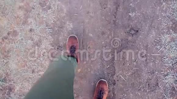 在村子里一个穿靴子的人走在地上视频的预览图