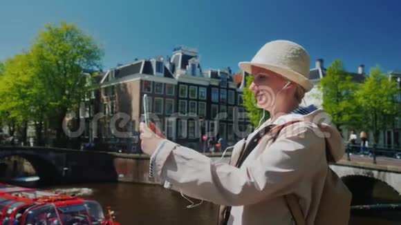 阿姆斯特丹一位年轻女子在运河旁自拍视频的预览图
