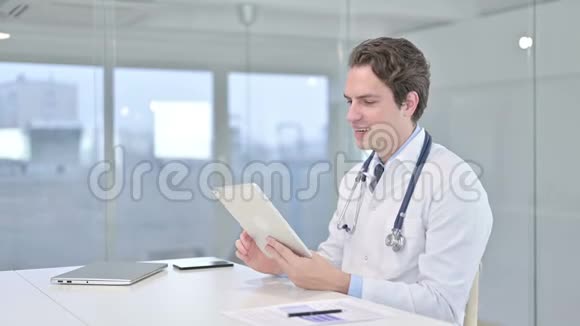 有吸引力的男医生在桌上做视频聊天视频的预览图