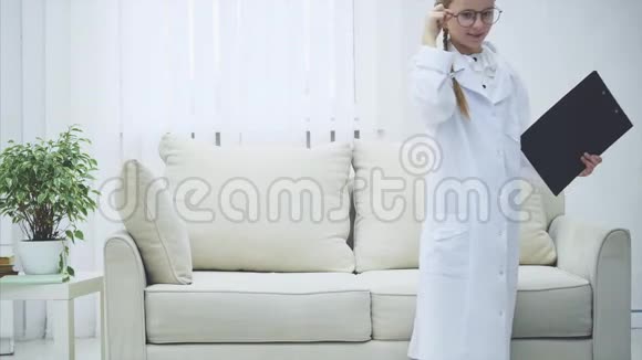 可爱的孩子戴着眼镜白大褂听诊器扮演着医生的角色视频的预览图