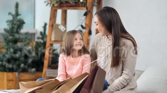 快乐的妈妈和可爱的女儿一起摆姿势感受爱享受圣诞假期的心情视频的预览图