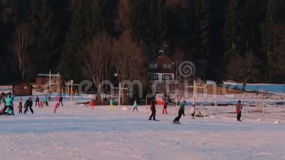 人们在山上的雪地里滑雪和滑雪板视频的预览图
