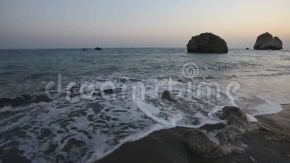 阿芙罗狄蒂在阳光明媚的夕阳下海滩和石头视频的预览图