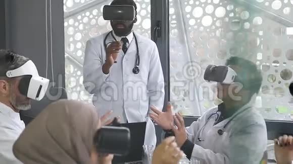 专业的讨人喜欢的非裔美国医生与虚拟现实眼镜一起工作视频的预览图