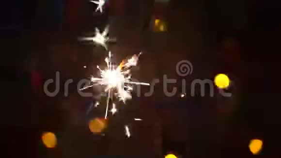 明亮的金色火花在灯光运动的背景上形成火花视频的预览图