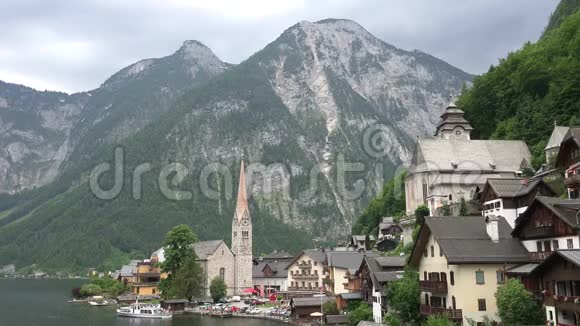 奥地利著名的城市村庄哈尔斯塔特位于达赫斯坦萨尔茨卡梅尔古特阿尔卑斯山的山谷中有教堂建筑和山脉视频的预览图