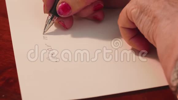 把老妇人的手收起来老太太用凝胶笔在白纸上写信侧视视频的预览图