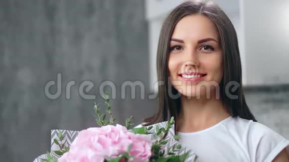 可爱的可爱女士的肖像完美的皮肤摆着嫩玫瑰和草本植物的味道特写视频的预览图