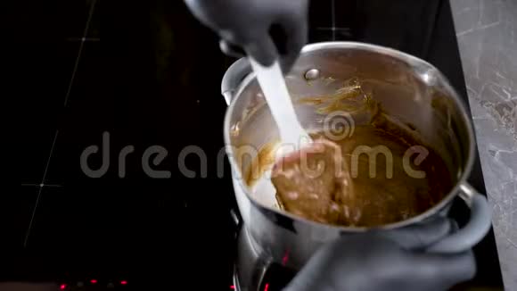 糖果机在炉子上搅拌混合物平底锅里有混合的烹饪原料视频的预览图