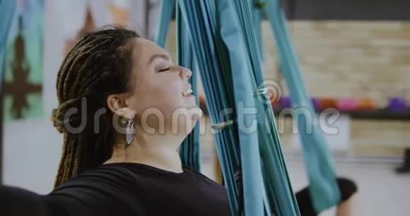 快乐的身体积极的女人在吊床上做伸展运动笑博比的位置开放的心态运动的智慧视频的预览图