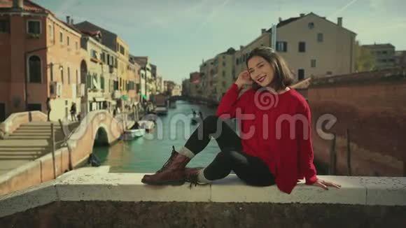 美丽的亚洲游客坐在威尼斯运河前复古颜色校正旅游生活方式理念视频的预览图