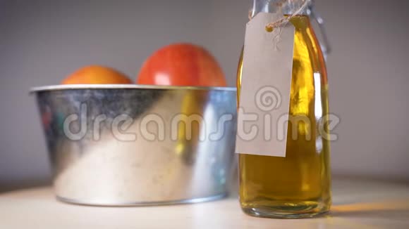 在木桌上的篮子里放着一瓶苹果汁和一个个苹果视频的预览图