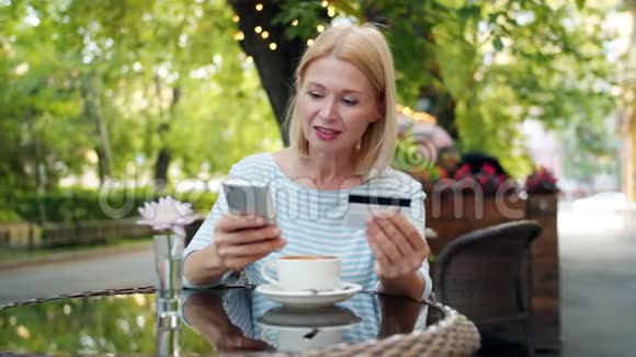 一个人在街头咖啡馆放松一个成熟的女士用银行卡支付视频的预览图