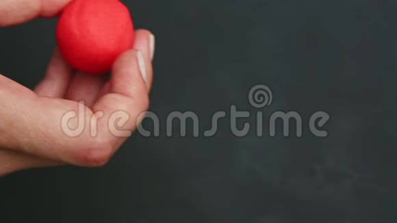上景特写女性双手展开一小块红色的杏仁糖视频的预览图
