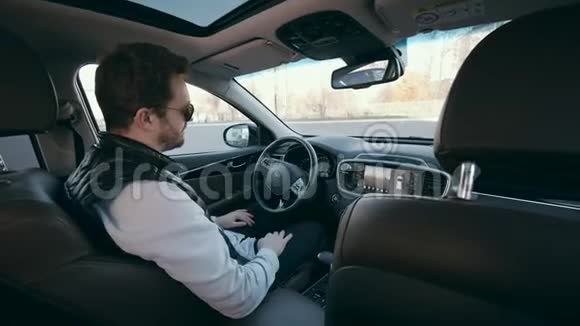 自动驾驶汽车的驾驶室一个微笑的人驾驶它自主自动驾驶自动驾驶汽车视频的预览图