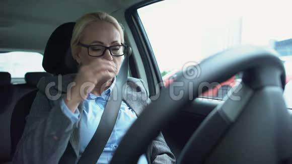 50多岁的商务小姐坐在驾驶座上感到眼睛紧张视频的预览图