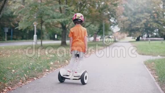 戴着头盔戴着铭文的小孩骑在陀螺仪上视频的预览图