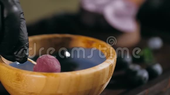 糕点厨师正在用焦糖蘸一块糖果用来浇上蓝莓蛋糕做特写视频的预览图
