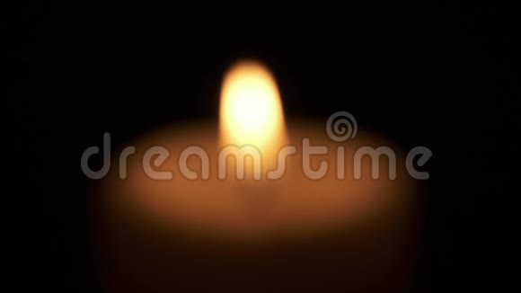 聚焦于黑暗中燃烧的单一蜡烛火焰视频的预览图