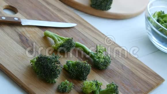 在厨房的餐板上切生的新鲜绿色西兰花白菜用刀煮切菜素食视频的预览图