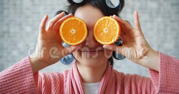 女孩的肖像头发卷着橘子藏着眼睛露出舌头视频的预览图