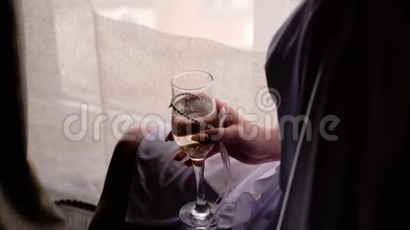 女孩坐在窗户前拿着一杯香槟视频的预览图