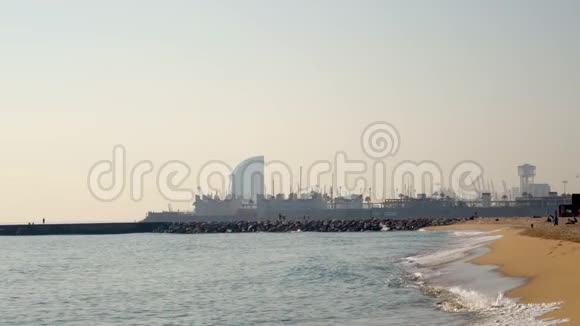 阳光明媚的一天巴塞罗那市海湾海滩有港口景观慢动作视频的预览图