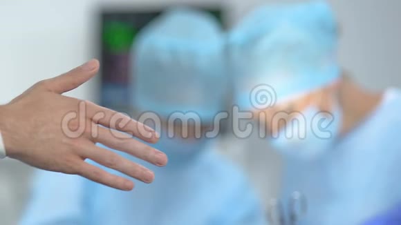 护士协助医生在手术前放置医用手套医院无菌视频的预览图
