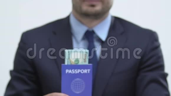 穿着西装的男子带着美元钞票的蓝色护照向美国移民劳工视频的预览图