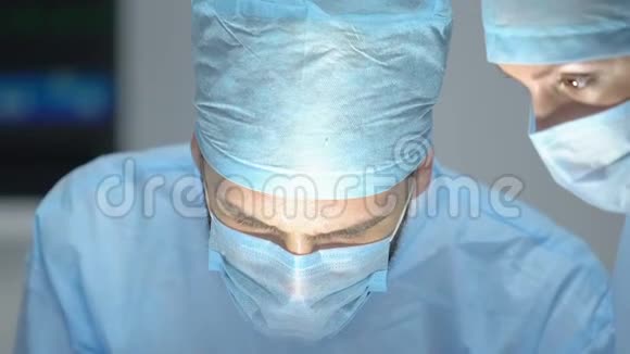 护士用棉花擦拭医生额头上的汗水手术困难视频的预览图