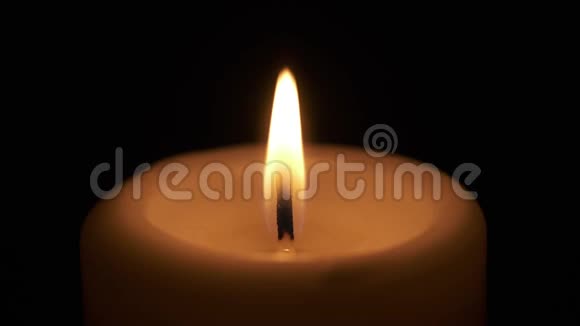 黑暗房间中燃烧的单一蜡烛火焰视频的预览图