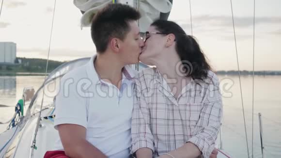 快乐的一对情侣在城市里的一艘帆船上接吻视频的预览图