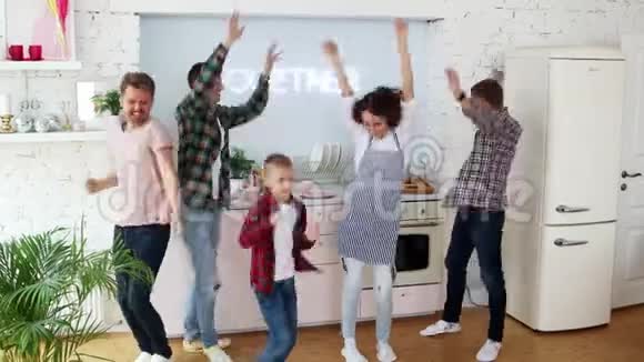 一群快乐的朋友在厨房里跳舞做饭视频的预览图