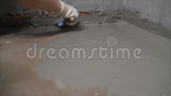 工工在施工现场铺设防水水泥的密封胶工人在露台上涂上液体箔工人视频的预览图