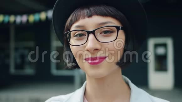 戴着帽子和眼镜的年轻美女的慢镜头视频的预览图